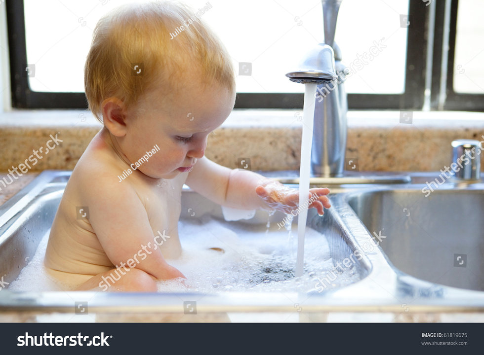 stock-photo-baby-having-a-bath-in-the-kitchen-sink-61819675.jpg